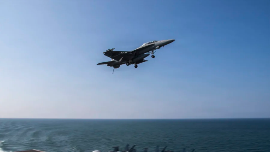 An F/A-18F Super Hornet flies over the flight deck of the aircraft carrier USS Abraham Lincoln in support of Operation Epic Fury in the Mediterranean Sea on March 6, 2026. (U.S. Navy via Getty Images)